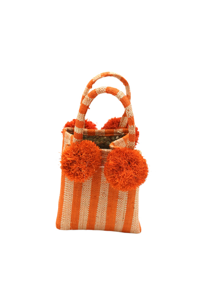 Schooner Coral Two Tone Stripe Straw Mini Bag with Pompom Accent handmade loomed natural raffia palm fiber in two tones of coral orange/red and natural straw color vertical stripe pattern with four matching raffia pompom embellishments at the base of each handle attachment tiny purse extra small handbag - Shebobo
