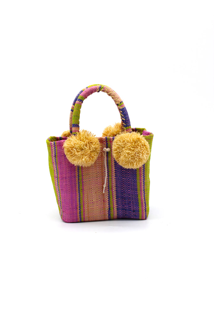 Schooner Lilac Swirl Straw Mini Bag with Pompom Accent handmade loomed natural raffia palm fiber in multi width vertical multicolor stripe pattern of  lilac pink/purple, lavender blue/purple, pink, natural straw color, lime green, etc. with four matching raffia pompom embellishments at the base of each handle attachment tiny purse extra small handbag - Shebobo