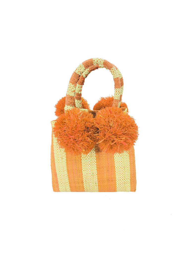 Schooner Orange Stripe Straw Mini Bag with Pompom Accent handmade loomed natural raffia palm fiber in two tones of orange and natural straw color vertical stripe pattern with four orange raffia pompom embellishments at the base of each handle attachment tiny purse extra small handbag - Shebobo
