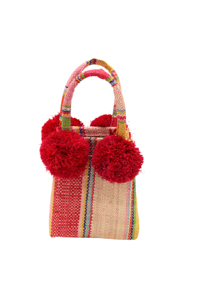 Schooner Raspberry Swirl Straw Mini Bag with Pompom Accent handmade loomed natural raffia palm fiber in multi width vertical multicolor stripe pattern of fuchsia hot/bright/barbie/pink, light pink, light blue, yellow, lime green, dusk navy/dark/blue, and natural straw color with four matching raffia pompom embellishments at the base of each handle attachment tiny purse extra small handbag - Shebobo