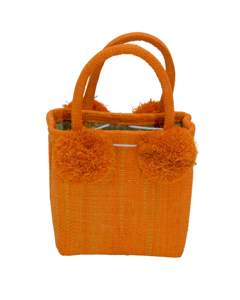 Schooner Straw Mini Bag with Pompom Accent handmade loomed natural raffia palm fiber in a solid hue of Saffron orange/yellow with four matching raffia pompom embellishments at the base of each handle attachment tiny purse extra small handbag - Shebobo