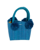 Schooner Straw Mini Bag with Pompom Accent handmade loomed natural raffia palm fiber in a solid hue of Turquoise blue/green with four matching raffia pompom embellishments at the base of each handle attachment tiny purse extra small handbag - Shebobo