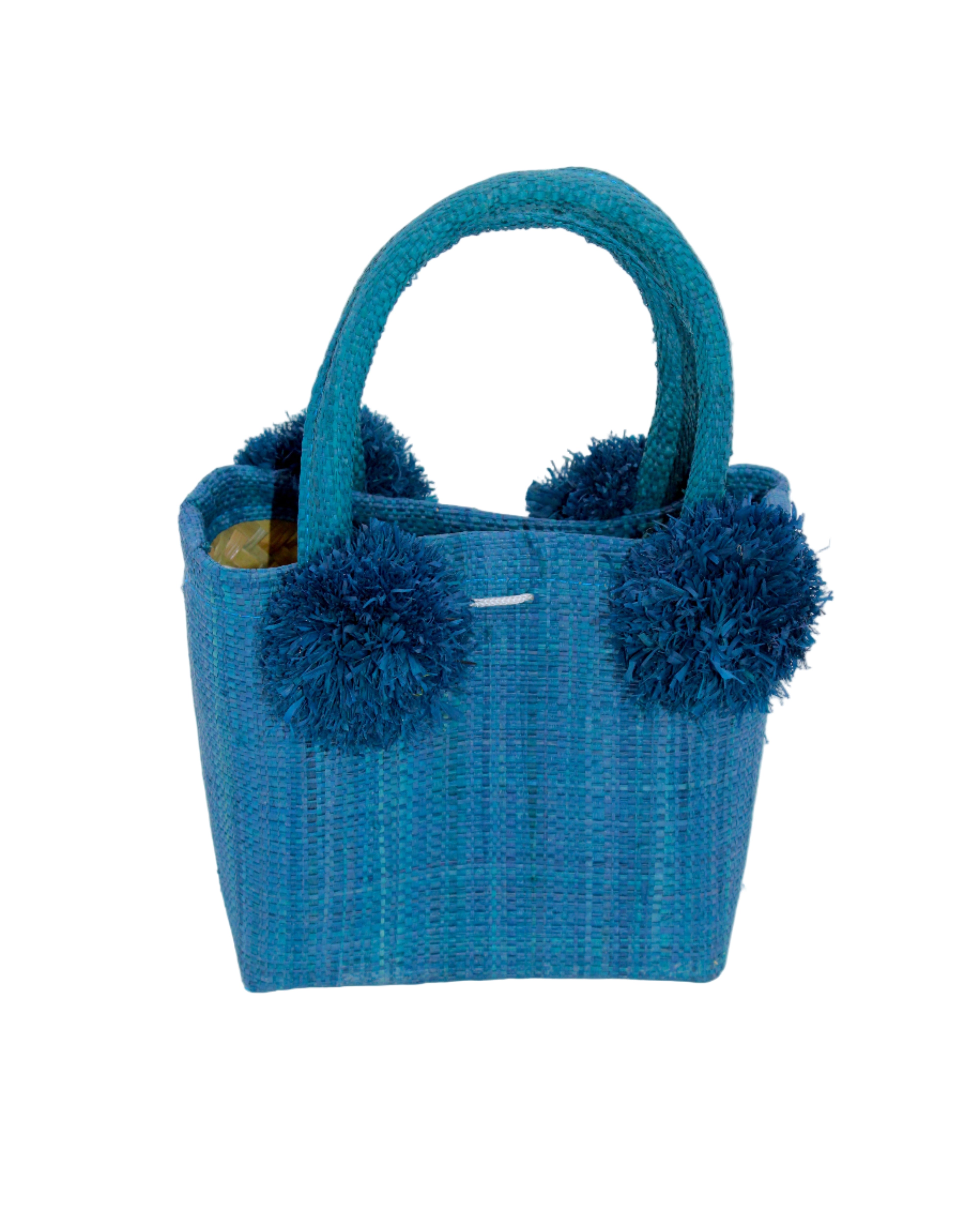Schooner Straw Mini Bag with Pompom Accent handmade loomed natural raffia palm fiber in a solid hue of Turquoise blue/green with four matching raffia pompom embellishments at the base of each handle attachment tiny purse extra small handbag - Shebobo