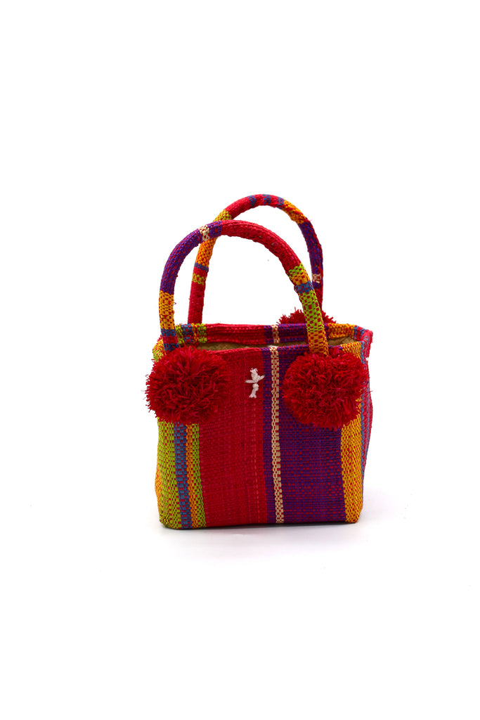 Schooner Watermelon Swirl Straw Mini Bag with Pompom Accent handmade loomed natural raffia palm fiber in multi width vertical multicolor stripe pattern of purple, orange, red, blue, white, yellow, green, etc. with four matching raffia pompom embellishments at the base of each handle attachment tiny purse extra small handbag - Shebobo