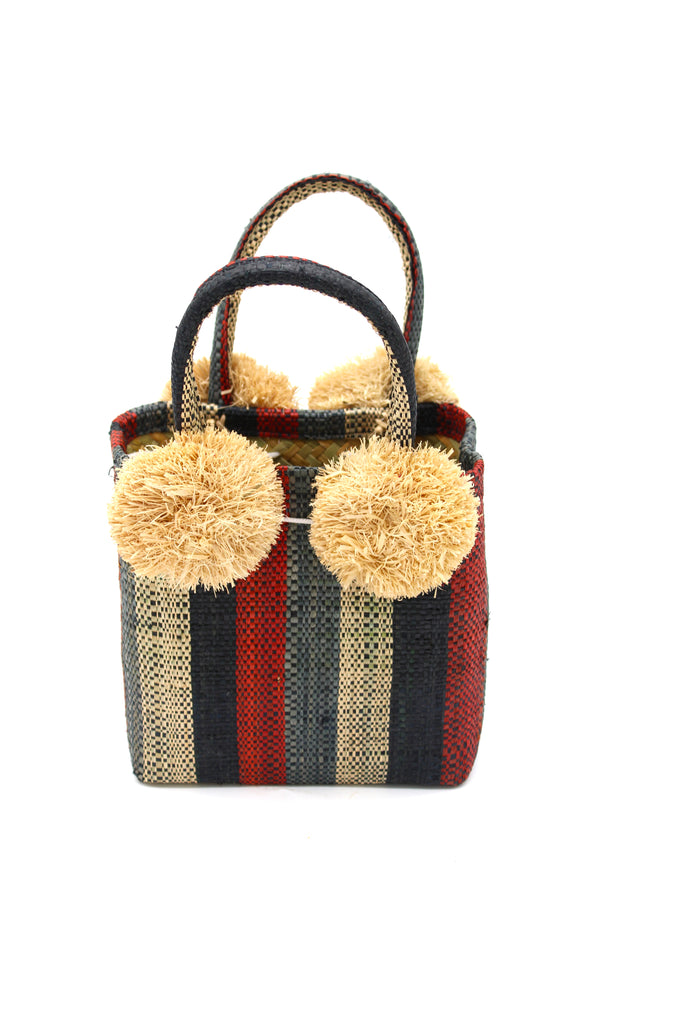 Schooner Whisky Stripe Straw Mini Bag with Pompom Accent handmade loomed natural raffia palm fiber in multi width vertical multicolor stripe pattern of grey, black, whisky brown/red, natural straw color, etc. with four matching raffia pompom embellishments at the base of each handle attachment tiny purse extra small handbag - Shebobo