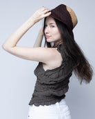 Model wearing Sequoia Cappuccino & Espresso 3" Brim Swirl Crochet Panama Unisex Straw Hats handmade crochet natural raffia palm fiber in a two tone color swirl design of cappuccino tea/light/brown and espresso dark/chocolate/brown spiraling together from wide bands around the brim to a narrow twist at the top of the crown  - Shebobo