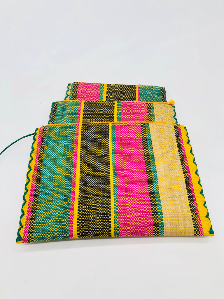Set of 3 Nesting Zippered Straw Clutches Carmalita Multicolor Stripe Pattern handmade loomed raffia in multiple widths of vertical stripes in turquoise, black, fuchsia, and saffron with matching zipper and braided zipper pull with cross stitch edging in three sizes of small, medium, and large - Shebobo