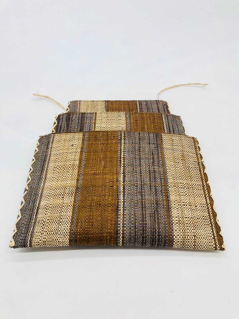 Set of 3 Nesting Zippered Straw Clutches Cinnamon Swirl Multicolor Stripe Pattern handmade loomed raffia in multiple widths of vertical stripes in natural, cinnamon/tobacco/brown, and grey with matching zipper and braided zipper pull with cross stitch edging in three sizes of small, medium, and large - Shebobo