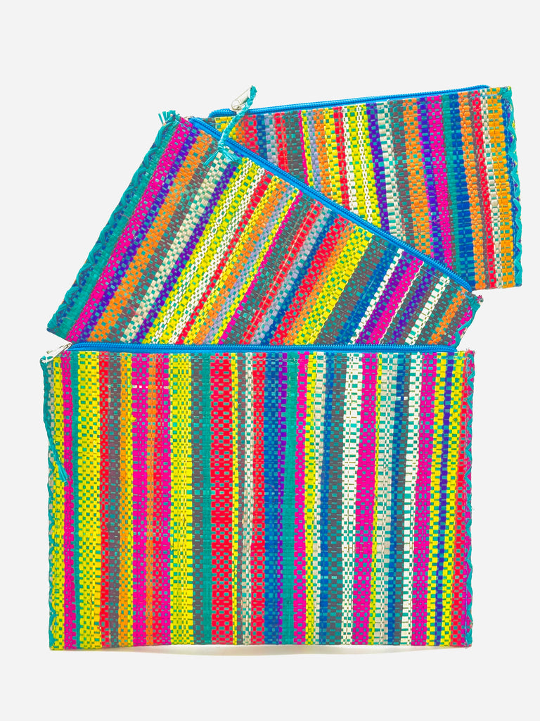 Set of 3 Nesting Zippered Straw Clutches Turquoise Stripe Multicolor Stripe Pattern handmade loomed raffia in multiple widths of vertical stripes in natural, orange, turquoise, saffron, seafoam, red, fuchsia pink, etc. with matching turquoise zipper and braided zipper pull with cross stitch edging in three sizes of small, medium, and large - Shebobo