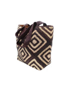 Side view Seychelle Mocha and Natural Diamond Pattern Crochet Straw Basket Handbag hSeychelle Espresso and Natural Diamond Pattern Crochet Straw Basket Handbag handmade natural raffia palm fiber in a two tone multicolor geometric diamond pattern with alternating Espresso chocolate/dark/brown and natural straw colored diamonds that make a diagonal bullseye pattern with matching crochet handles beach bag tote purse - Shebobo