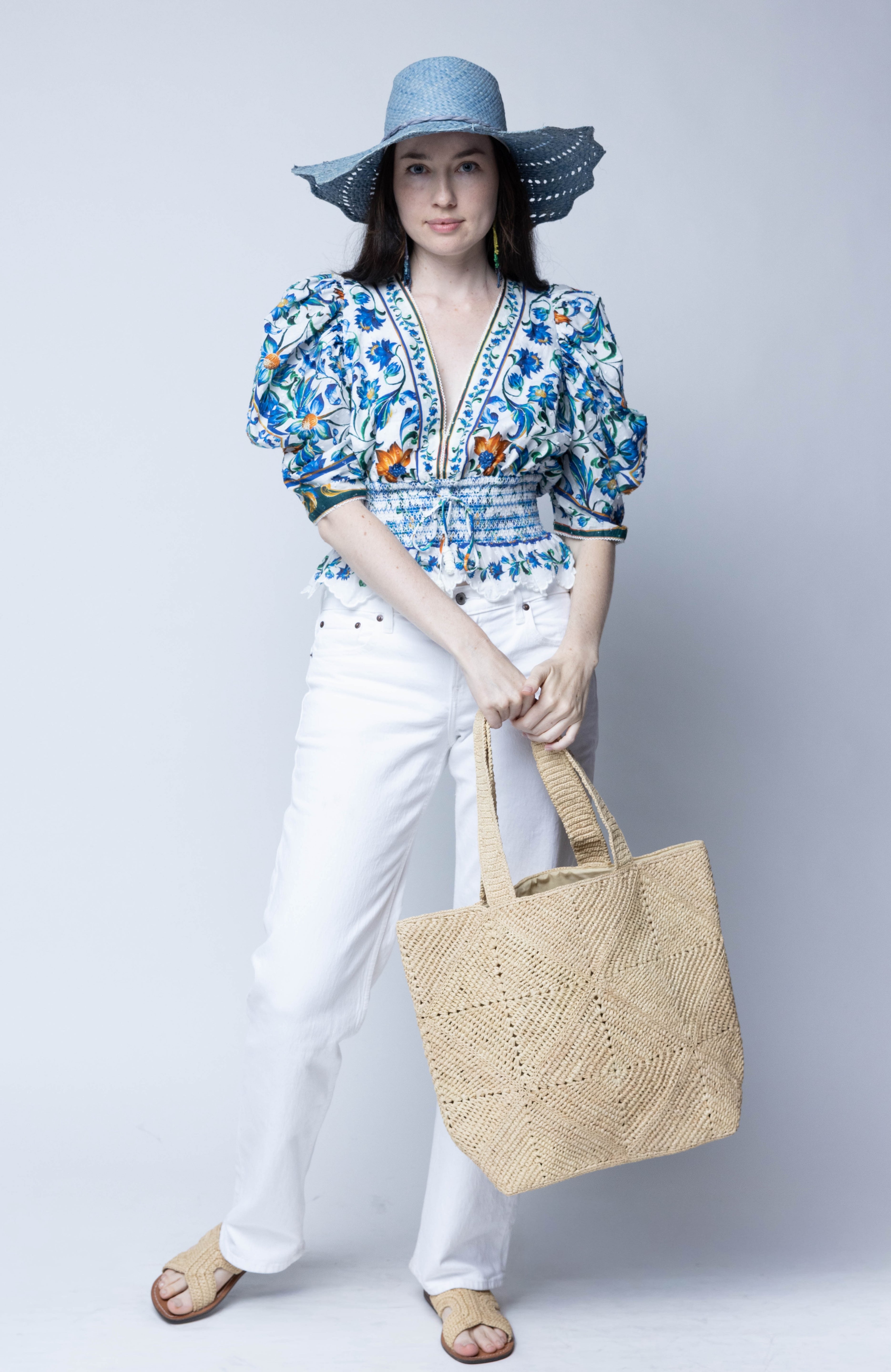 Model wearing Seychelle Natural Diamond Pattern Crochet Straw Basket Handbag handmade natural raffia palm fiber in a solid hue of natural straw color with subtle geometric diamond diagonal pattern with matching crochet handles beach bag tote purse - Shebobo (with Sara 4.5" Brim Woven Straw Sun Hats with Zigzag Edge)