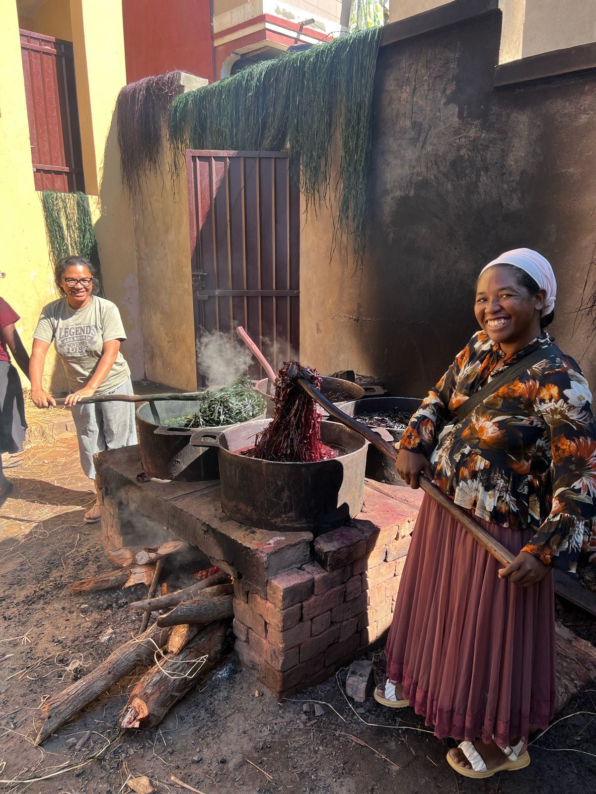 Shebobo Artisans in Madagascar dying raffia palm fibers to be used in handmade loomed or crochet natural straw accessories for Shebobo