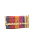 Sophie Sassafras Swirl Multicolor Stripes Straw Clutch handmade loomed raffia purse handbag  in muti-width vertical bands of dark blue, fuchsia pink, red, saffron yellow, and natural straw color with matching cross stitch edging and natural straw color raw fringe edge envelope shaped bag - Shebobo