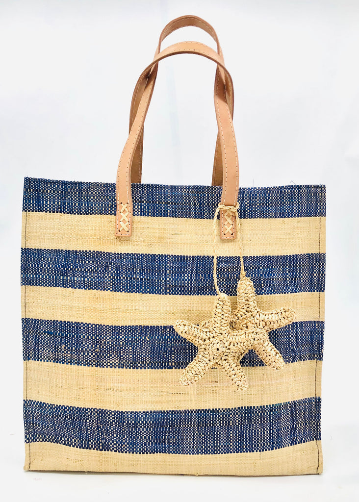 Starfish Blue Straw Bag with Crochet Starfish Charm Embellishment handmade loomed raffia shopping tote in navy blue and natural straw color horizontal wide stripe pattern handbag with leather handles - Shebobo