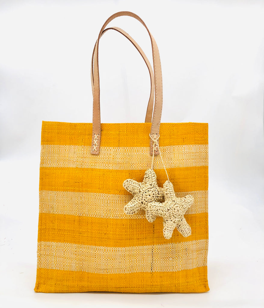 Starfish Straw Bag with Crochet Starfish Charm Embellishment handmade loomed raffia shopping tote in saffron yellow and natural straw color horizontal wide stripe pattern handbag with leather handles - Shebobo