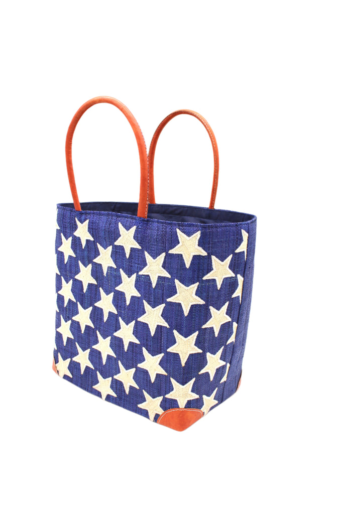 Side View Stars Straw Basket Bag handmade loomed raffia palm fiber in a solid hue of Dusk navy/dark/blue with natural straw color loomed stars stitched on in a tight  diagonal pattern with leather handles Patriotic Americana Shoulder Bag Beach Bag - Shebobo