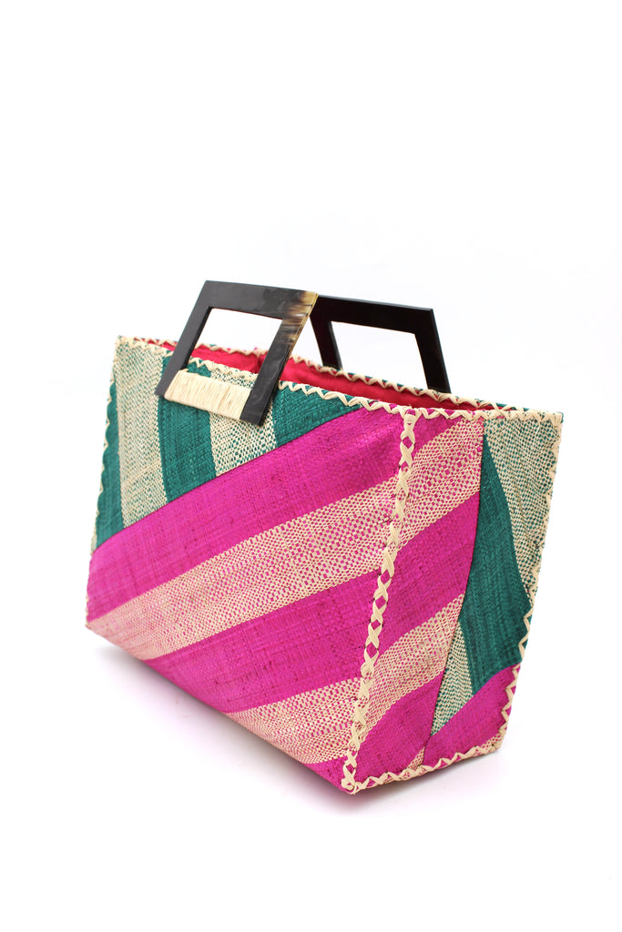 Side View Stevie Double Wide Stripe Fuchsia & Teal Square Straw Handbag with Horn Handles handmade loomed raffia palm fiber in even width wide stripe pattern of Fuchsia hot/bright/barbie/pink and natural straw color oriented on the diagonal of three quarters of the bag with matching stripe pattern of Teal dark/blue/green and natural diagonally on the top left corner quarter shoulder bag handbag - Shebobo