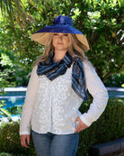 Model wearing Sweet Meadow Scarf Wrap Blue Multicolor Floral Pattern with black, white, blue, turquoise, orange, etc. - Shebobo (with 7" Wide Brim Two Tone Packable Straw Sun Hat)