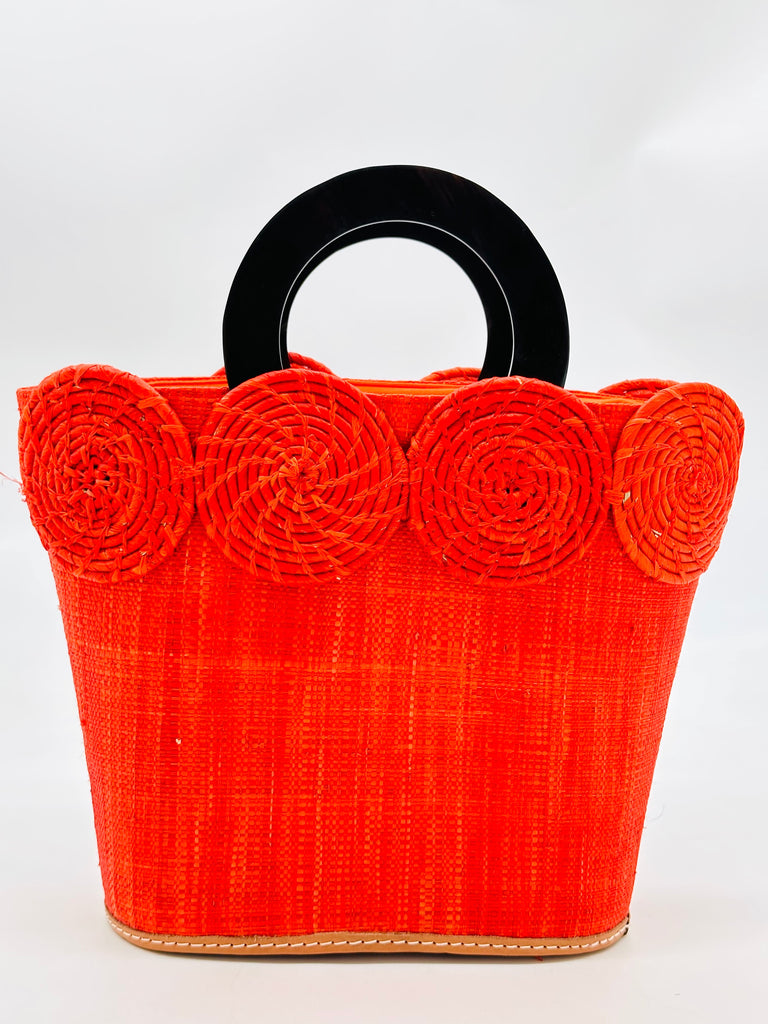Tazi Disc Straw Handbag with Horn Handle handmade loomed raffia purse in coral orange/red with wrapped raffia disc embellishment small bag - Shebobo