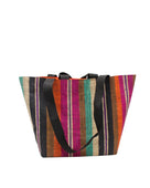 Tiburon Revel Swirl Straw Duffle Bag Shoulder & Handbag Combination handmade loomed natural raffia palm fiber in a multicolor vertical stripe pattern of multi width bands of black, fuchsia pink, coral orange/red, seafoam blue/green, tobacco brown, purple, and natural straw color, etc. with four black webbing handles sports tote bag purse - Shebobo