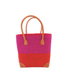 Trinidad Fuchsia and Coral Two Tone Straw Basket Bag handmade loomed raffia palm fiber in a two tone color block pattern with coral orange/red on the bottom half and fuchsia hot/bright/barbie/pink on the top half of the bag with leather handles and accents beach bag tote purse - Shebobo