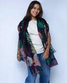 Model wearing Tropical Forest Scarf Wrap Black & Wine Multicolor leaves and floral pattern with black, wine burgundy/red, kelly green, light green, blush orange/pink, beige, etc. - Shebobo