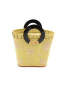 Tulum Straw Bucket Bag with Flower Embroidery and Horn Handle Butter Purse with Ruffle Edge handmade loomed raffia palm fiber in a solid hue of butter light/yellow with natural straw color hand embroidered floral pattern with multiple sized flowers and raffia ruffle on the opening  handbag - Shebobo