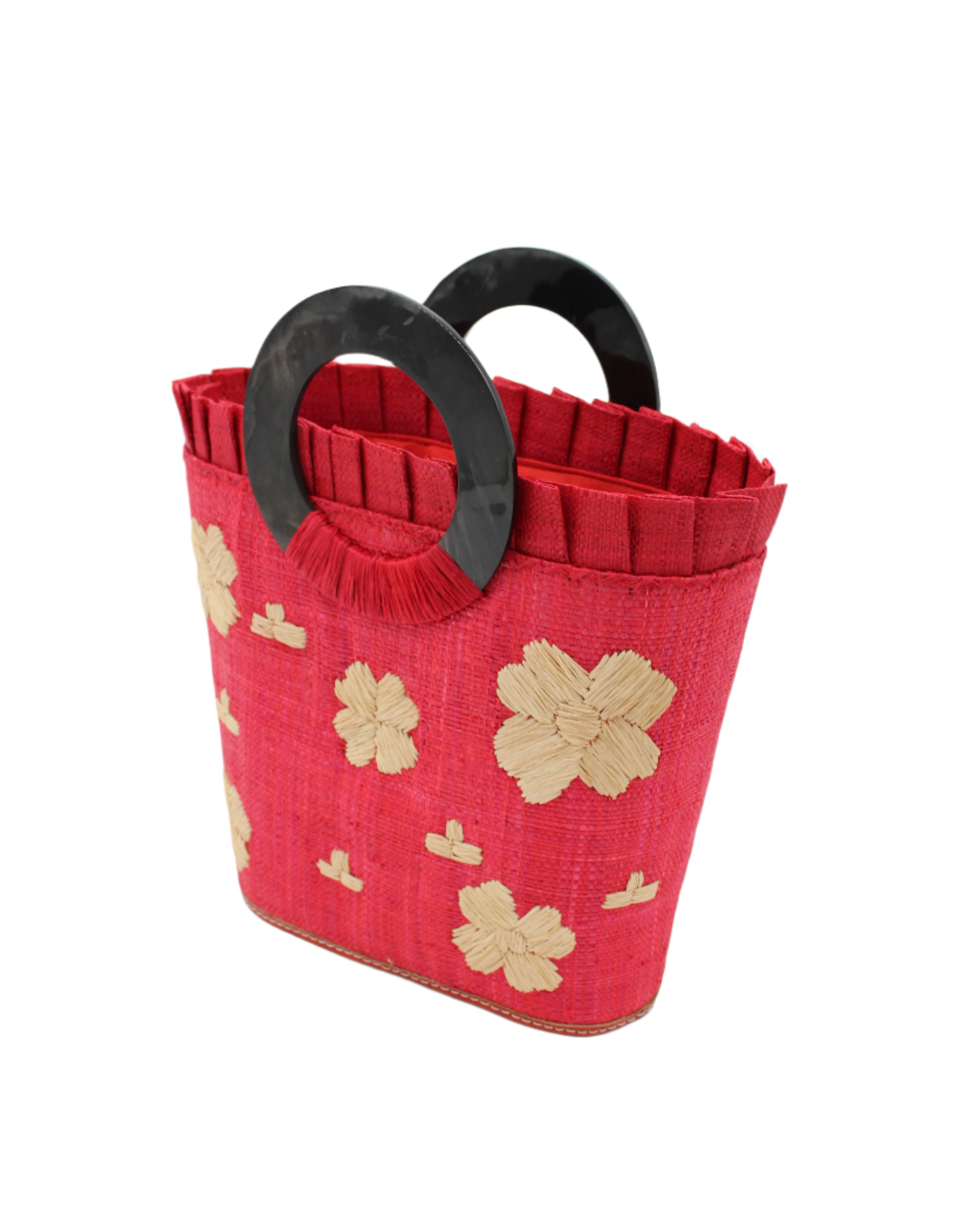 Side view Tulum Straw Bucket Bag with Flower Embroidery and Horn Handle Red Purse with Ruffle Edge handmade loomed raffia palm fiber in a solid hue of red with natural straw color hand embroidered floral pattern with multiple sized flowers and raffia ruffle on the opening  handbag - Shebobo
