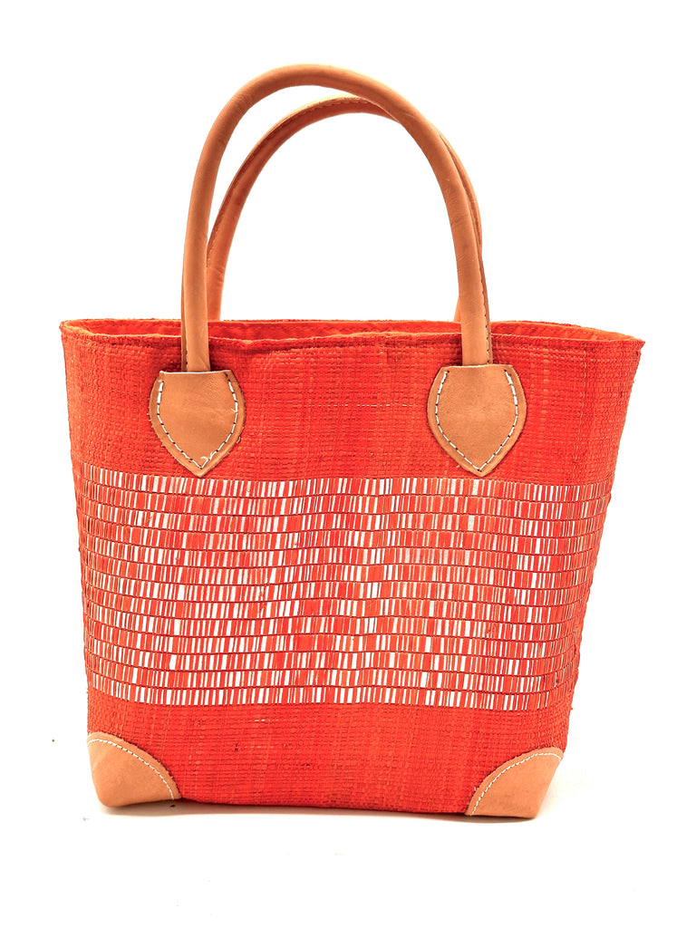 Wynwood Coral Straw Basket Bag with Metallic Detailing Handmade loomed raffia palm fiber in a solid hue of coral orange/red with a wide horizontal band of metallic strands woven in seamlessly handbag purse with leather handles - Shebobo