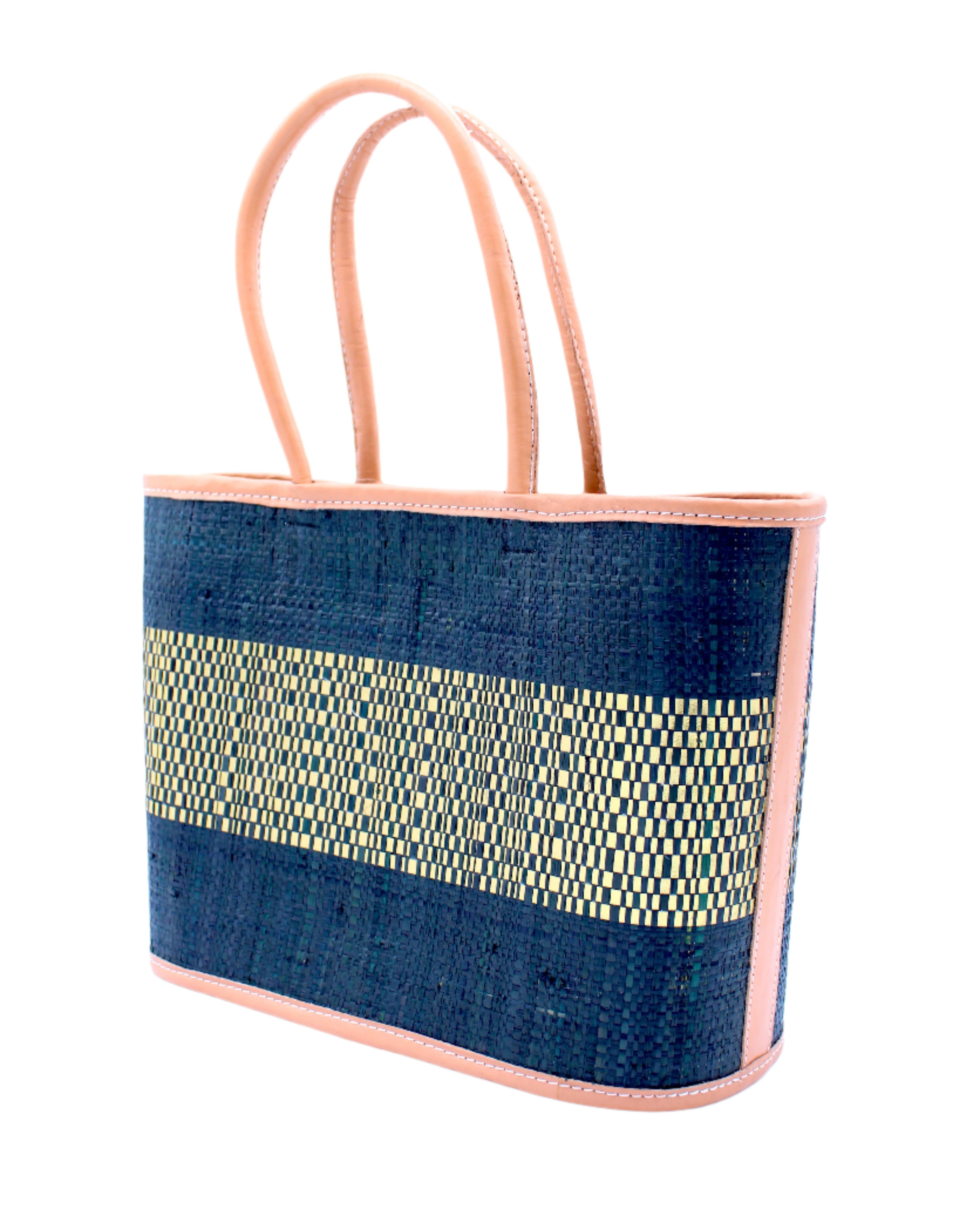 Side View Wynwood Black Straw Basket Bag Handbag with Metallic Detailing handmade loomed raffia in black and silver metallic vegan leather in three evenly sized horizontal bands of color with the metallic weave centered on the purse with leather binding and handles - Shebobo