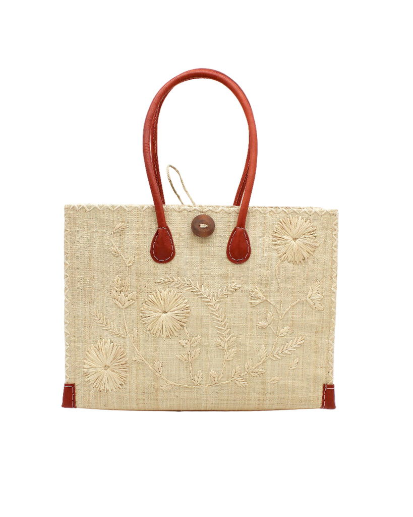 Zafran Natural Embroidered Straw Beach Bag with Floral Pattern handmade natural raffia palm fiber in a solid hue of natural straw color with asymmetrical floral leaf, vine, and flower pattern in Natural with matching cross-stitch edging, leather handles, and wooden button closure shoulder bag handbag tote - Shebobo