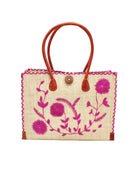 Zafran Natural & Fuchsia Embroidered Straw Beach Bag with Floral Pattern handmade natural raffia palm fiber in a solid hue of natural straw color with asymmetrical floral leaf, vine, and flower pattern in fuchsia hot/bright/barbie/pink with matching cross-stitch edging, leather handles, and wooden button closure shoulder bag handbag tote - Shebobo