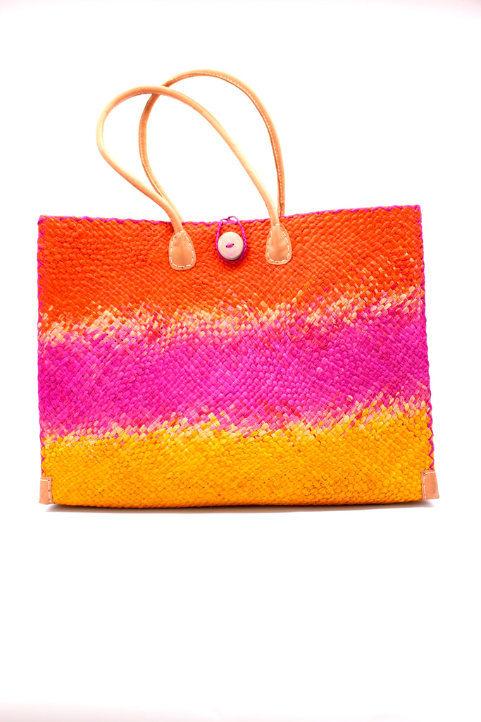 Holden Fuchsia Ombre Zafran Large Straw Beach Bags handmade dip dyed raffia woven into a three part horizontal ombre pattern of coral orange/red on the top, fuchsia pink in the middle and both sides, and saffron yellow on the bottom with cross stitch edging, wooden button, and leather handles - Shebobo