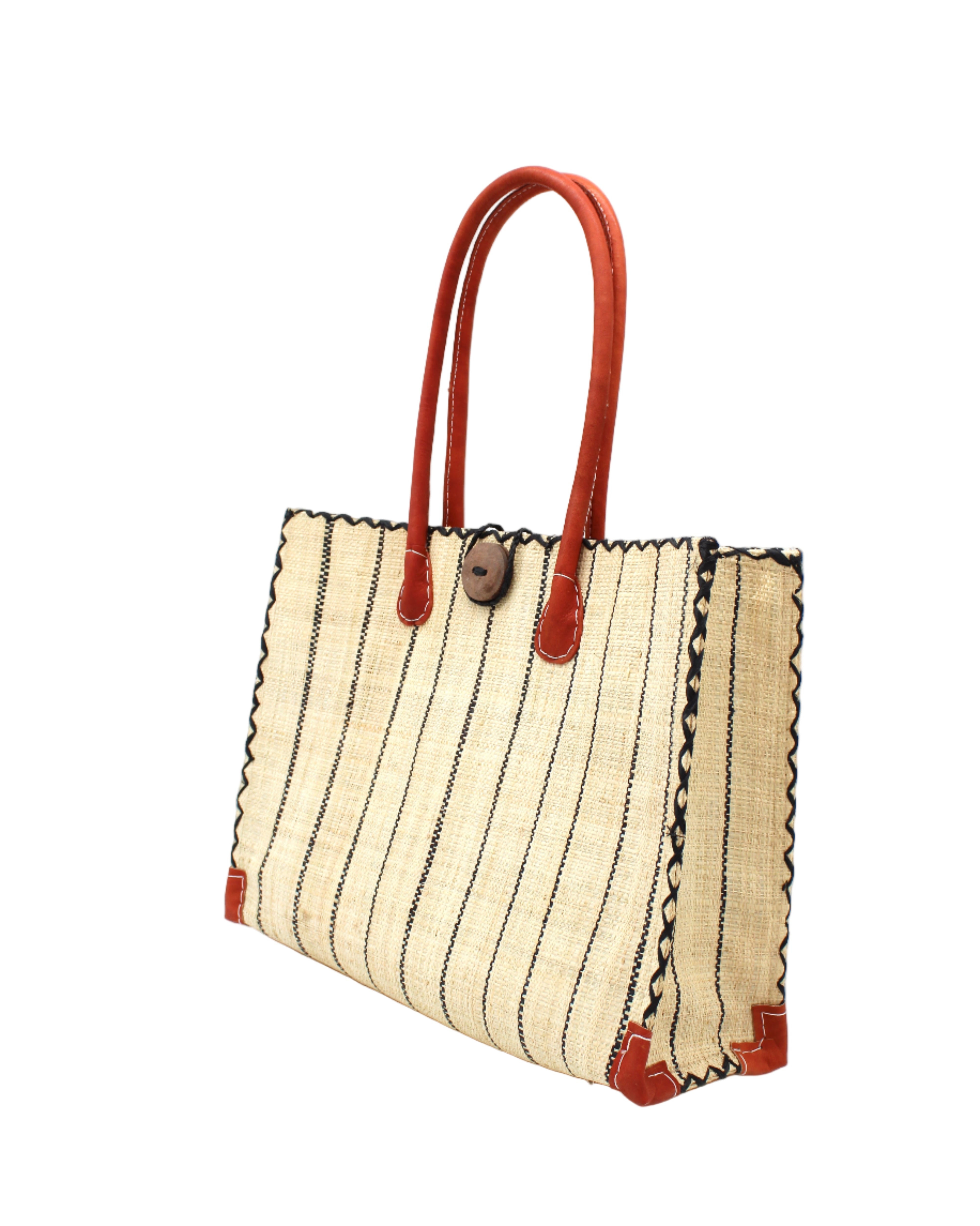 Side view Zafran Natural Pinstripes Large Straw Beach Bag with Plastic Liner handmade loomed raffia tote in wide bands of natural straw color with narrow bands of black that make a vertical pinstripe pattern with assorted print plastic lining and leather handles xl bag - Shebobo