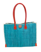 Zafran Straw Beach Bag with Plastic Liner handmade loomed raffia in a solid hue of Turquoise blue/green with contrasting natural straw color cross stitch edge binding, wood button closure, and leather handles & feet plus assorted print plastic lining - Shebobo