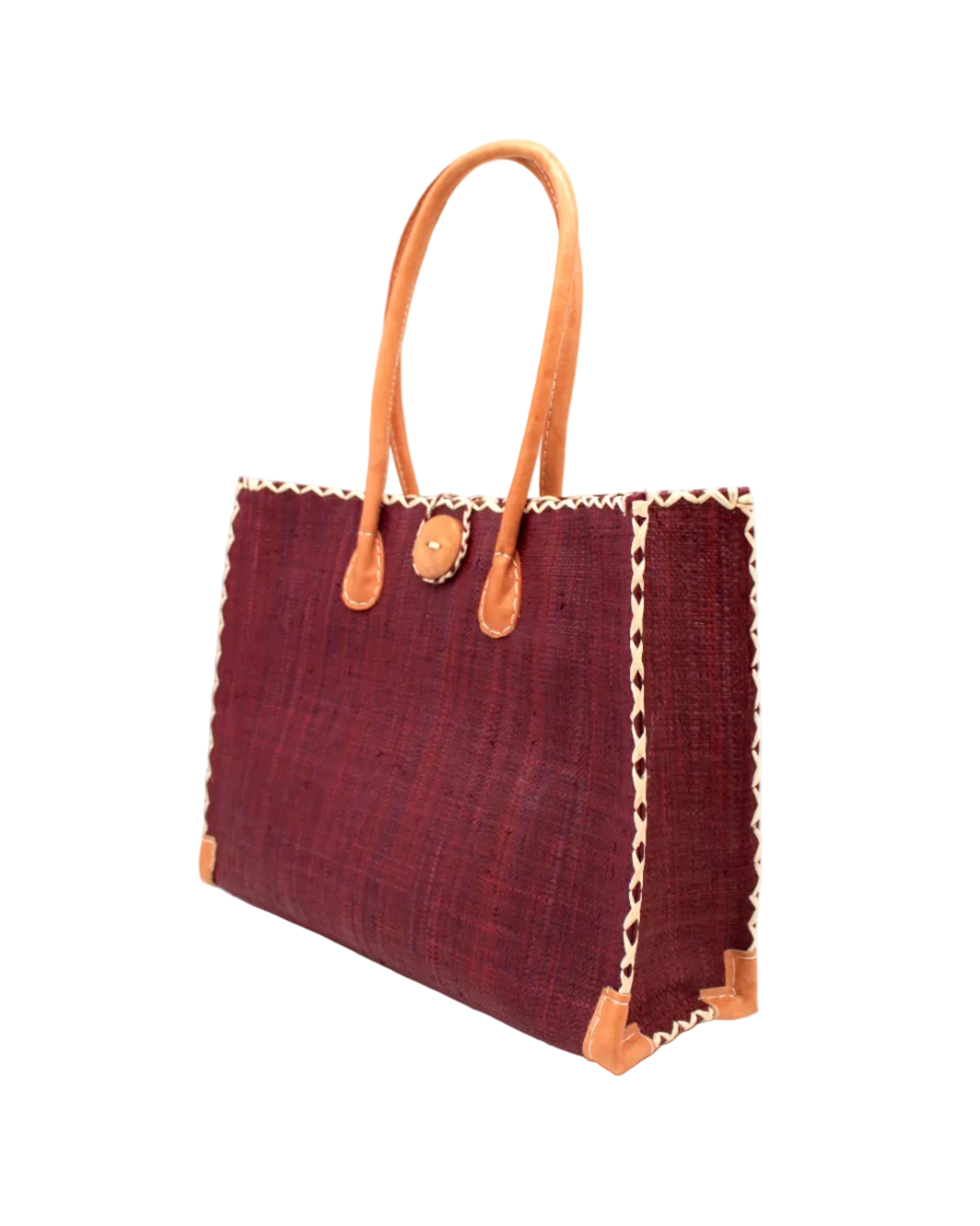 Side view Zafran Straw Beach Bag with Plastic Liner handmade loomed raffia in a solid hue of Umberwine burgundy/bordeaux/clared/dark/red/purple with contrasting natural straw color cross stitch edge binding, wood button closure, and leather handles & feet plus assorted print plastic lining - Shebobo