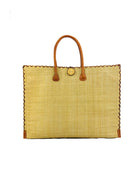 Zafran Straw Beach Bag with Plastic Liner handmade loomed raffia in natural straw color with contrasting cross stitch edge binding, wood button closure, and leather handles & feet plus assorted print plastic lining - Shebobo