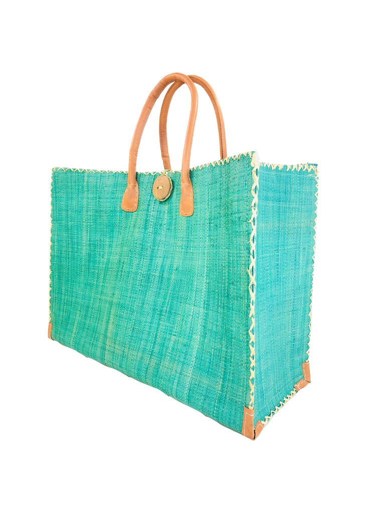 Zafran Straw Beach Bag with Plastic Liner handmade loomed raffia in Seafoam light blue/green with contrasting cross stitch edge binding, wood button closure, and leather handles & feet plus assorted print plastic lining - Shebobo