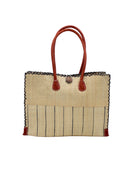 Zafran Two Tone Wide Stripe Natural Pinstripe Straw Beach Bag handmade loomed raffia palm fiber in a solid hue of natural straw color on the top half of the bag and a multicolor multi-width vertical pinstripe stripe pattern with thin bands of black with wide bands of natural on the bottom half of the bag with leather handles and feet and matching crosshatch stitch edging shoulder bag - Shebobo