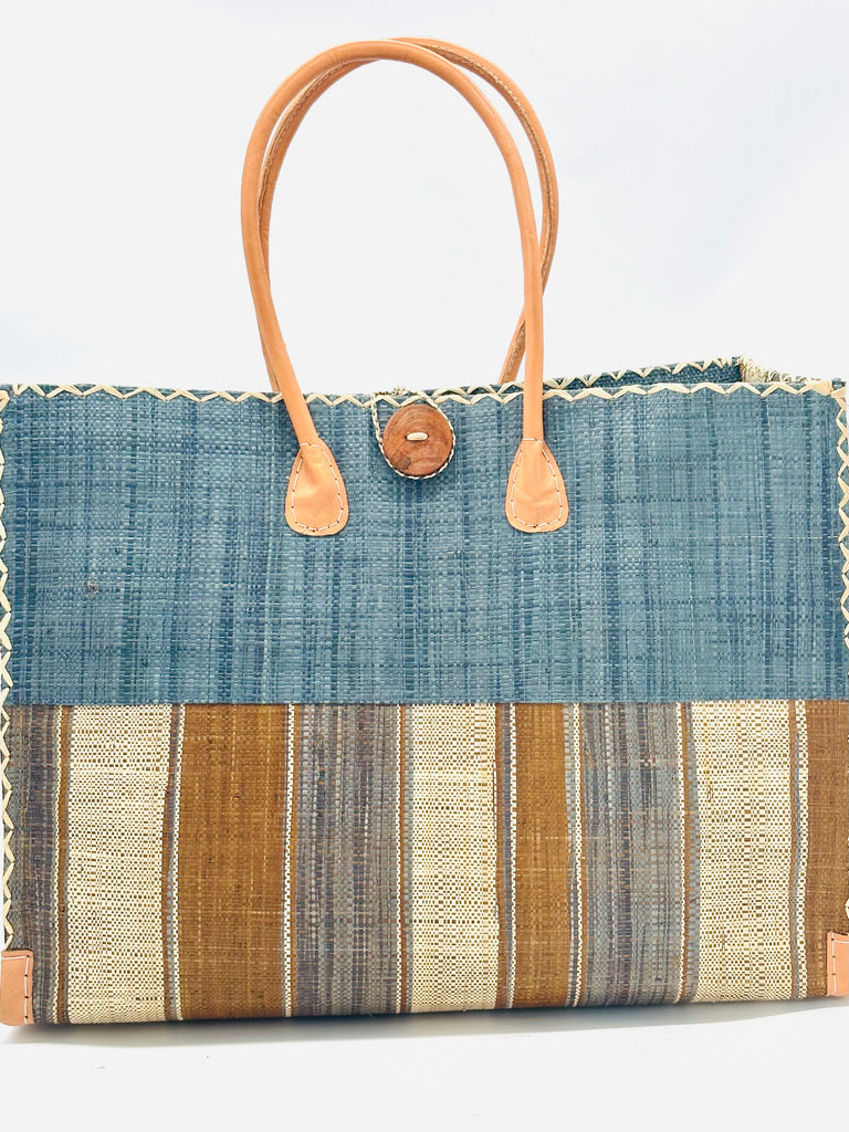 Zafran Two Tone Cinnamon Swirl Multicolor Stripes Beach Straw Bag with Plastic Liner handmade loomed raffia color block with the top half solid grey and the bottom half multi width vertical stripes of Cinnamon/Tobacco/Brown, Grey, and Natural - sides of bag are same stripe pattern - with wood button and leather handles & accents - Shebobo