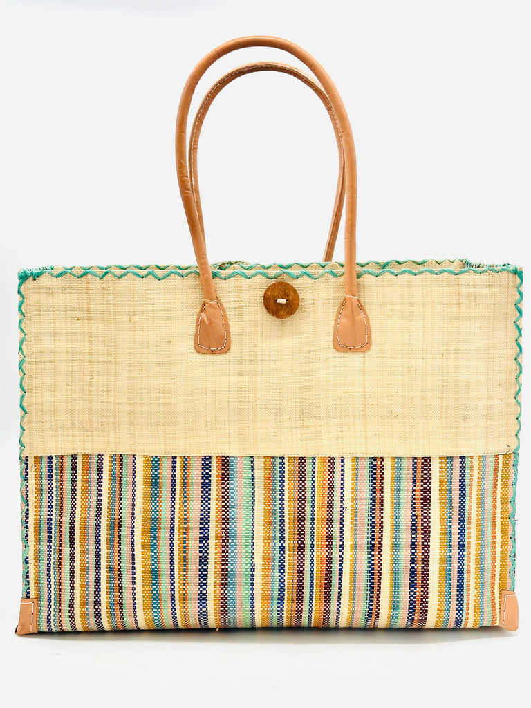 Zafran Two Tone Taffy Multicolor Stripes Beach Straw Bag with Plastic Liner handmade loomed raffia color block with the top half solid natural straw color and the bottom half multi width vertical stripes of natural, seafoam, bordeaux, orange, saffron, blue, etc. - sides of bag are same stripe pattern - with wood button and leather handles & accents - Shebobo