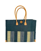 Zafran Two Tone Wide Stripe Black Swirl Straw Beach Bag handmade loomed raffia palm fiber in a solid hue of black on the top half of the bag and a multicolor multi-width vertical stripe pattern of black, grey, and natural straw color on the bottom half of the bag with leather handles and feet and matching crosshatch stitch edging shoulder bag - Shebobo
