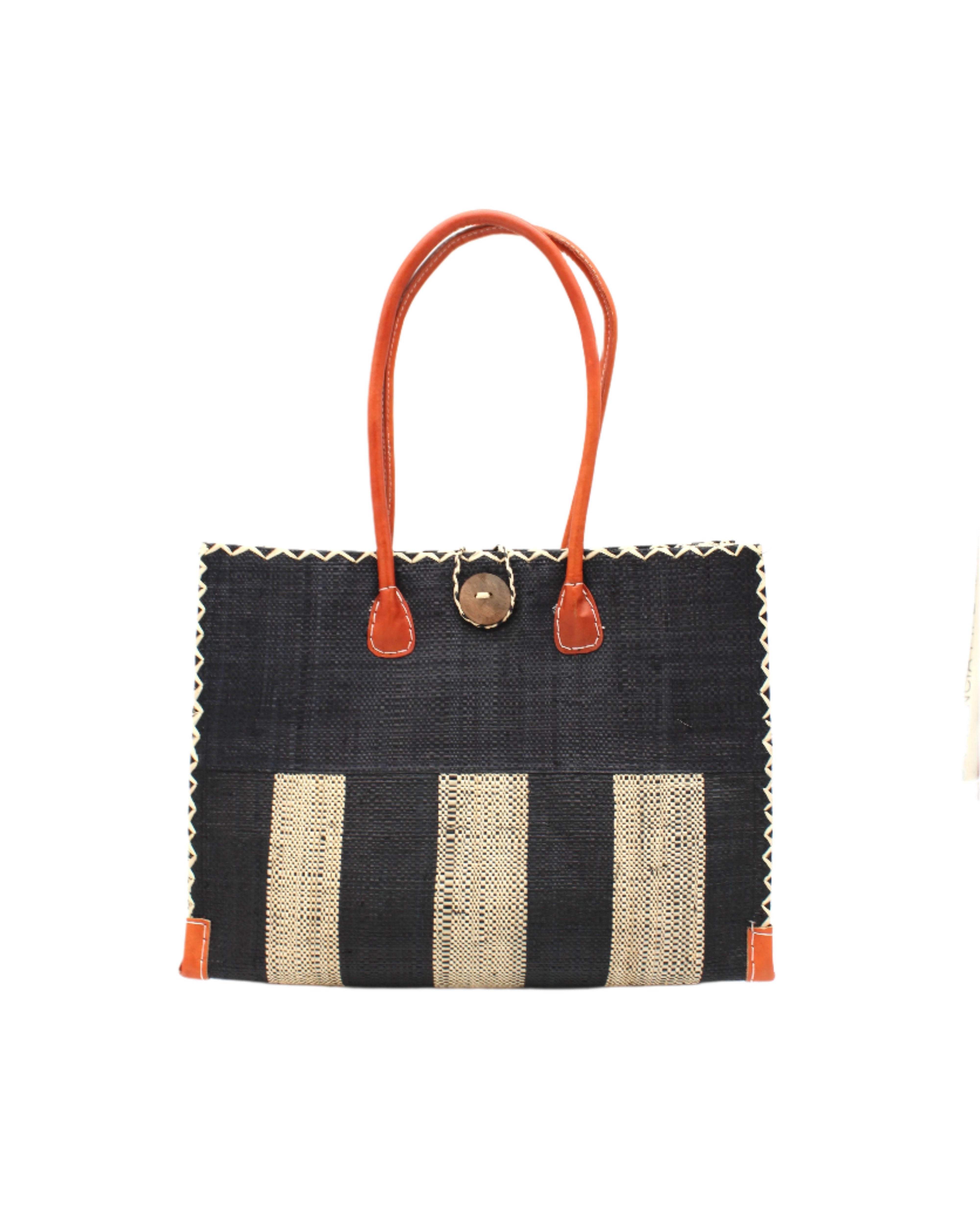 Zafran Two Tone Wide Stripe Black and Natural Straw Beach Bag handmade loomed raffia palm fiber in a solid hue of black on the top half of the bag and a two tone even width vertical wide stripe pattern of black and natural straw color on the bottom half of the bag with leather handles and feet and matching crosshatch stitch edging shoulder bag - Shebobo