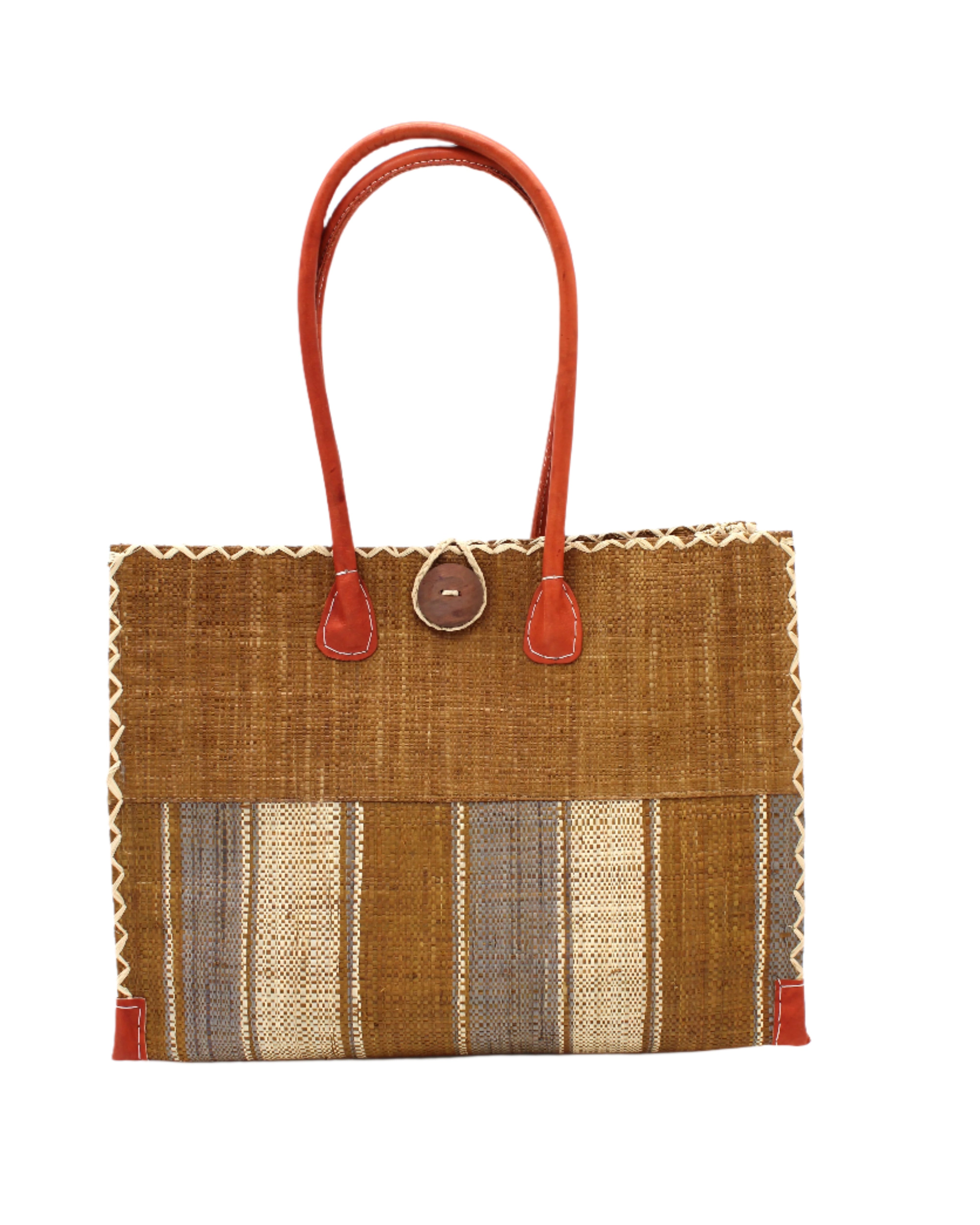 Zafran Two Tone Wide Stripe Cinnamon Swirl Straw Beach Bag handmade loomed raffia palm fiber in a solid hue of cinnamon tobacco/dark/brown on the top half of the bag and a multicolor multi-width vertical stripe pattern of cinnamon, grey, and natural straw color on the bottom half of the bag with leather handles and feet and matching crosshatch stitch edging shoulder bag - Shebobo