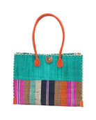 Zafran Two Tone Wide Stripe Revel Swirl Straw Beach Bag handmade loomed raffia palm fiber in a solid hue of Teal dark/blue/green on the top half of the bag and a multicolor multi-width vertical stripe pattern of black, cinnamon tobacco/dark/brown, teal, coral orange/red, fuchsia hot/bright/barbie/pink, and natural straw color on the bottom half of the bag with leather handles and feet and matching crosshatch stitch edging shoulder bag - Shebobo