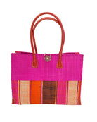 Zafran Two Tone Wide Stripe Whimsy Swirl Straw Beach Bag handmade loomed raffia palm fiber in a solid hue of Fuchsia hot/bright/barbie/pink on the top half of the bag and a multicolor multi-width vertical stripe pattern of black, coral red/orange, fuchsia, and natural straw color on the bottom half of the bag with leather handles and feet and matching crosshatch stitch edging shoulder bag - Shebobo