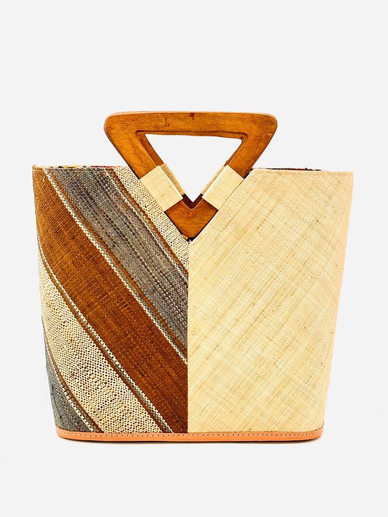 Zuki Two Tone Cinnamon Swirl Straw Handbag With Wood Triangle Handle handmade loomed raffia vertically halved visually with one side of multicolor cinnamon/tobacco/brown, grey, and natural multi width stripe pattern on a diagonal with the other half solid natural boho chic purse bag - Shebobo