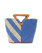 Zuki Two Tone Denim Straw Handbag With Wood Triangle Handle handmade loomed raffia palm fiber in a two tone pattern with the left half of the bag even width stripes of denim retro/light/blue and natural straw color oriented as a diagonal stripe and the right half of the bag a solid hue of denim with carved wood handles - Shebobo