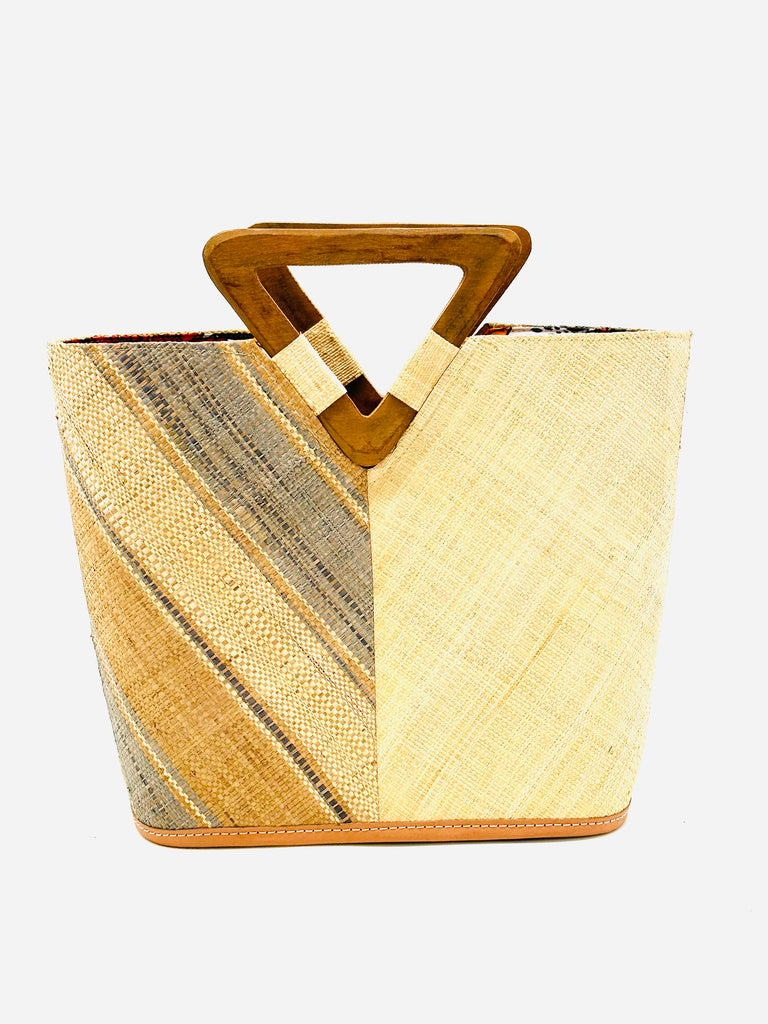 Zuki Two Tone Latte Swirl Straw Handbag With Wood Triangle Handle handmade loomed raffia vertically halved visually with one side of multicolor latte/light brown, grey, and natural multi width stripe pattern on a diagonal with the other half solid natural boho chic purse bag - Shebobo