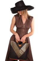 Zuki Wynwood Black Straw Handbag with Metallic Detailing & Wood Triangle Handle handmade loomed raffia palm fiber in a solid hue of black with incorporated vegan leather  gold metallic strands in a V pattern across the front and back of the bag with assorted print African wax cloth liners and carved wooden triangle handle purse - Shebobo (with 5" & 7" Wide Brim Solid Color Straw Sun Hats with Big Bow)